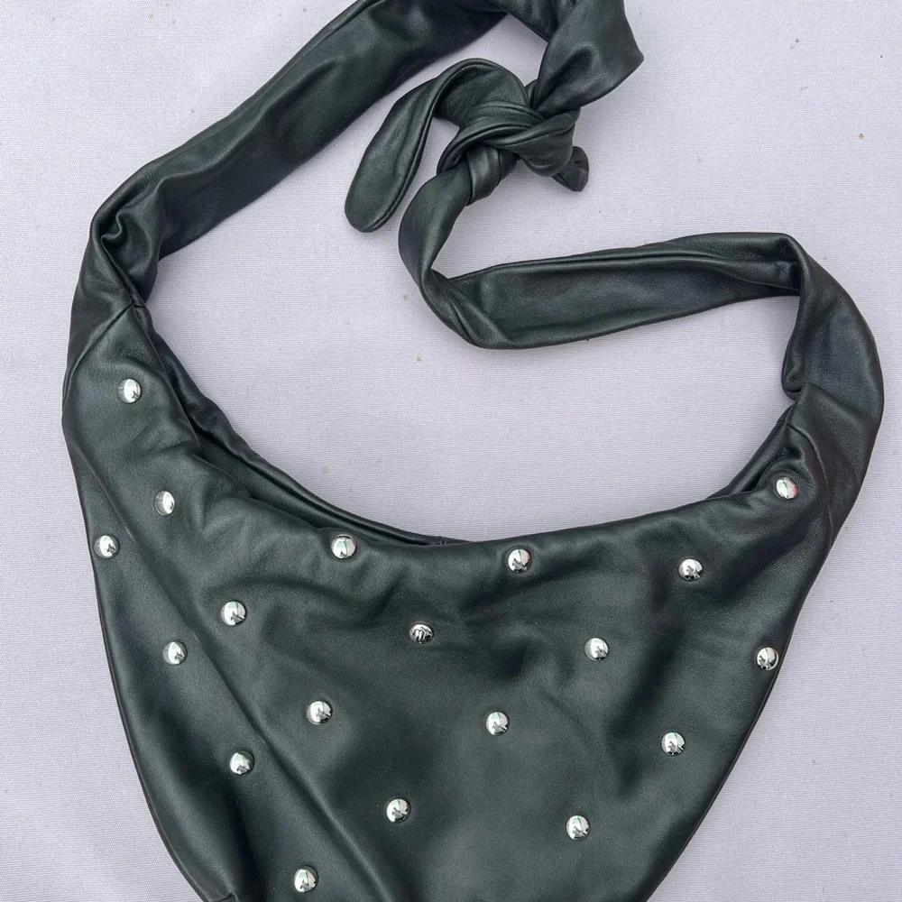 Maje “le bow bag” in black leather with silver studs
